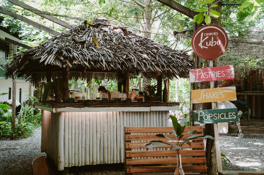 Cozy interior of Charlie's Kubo in Kalye Artisano with fresh shakes, coffee, and an assortment of pastries like croissants, chocolate chip banana bread, brownies, and ube crinkles.